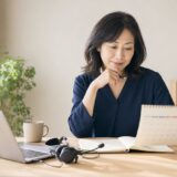 仕事で英語が必要になる期限を確認しながらビジネス英会話の学習計画を立てる女性